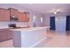 Bright kitchen featuring an island with bar seating, stainless steel appliances and light-colored countertops at 1255 N Arizona Ave # 1216, Chandler, AZ 85225