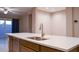 Kitchen island featuring a stainless steel faucet, sink, dishwasher, and a sleek white countertop at 1255 N Arizona Ave # 1216, Chandler, AZ 85225
