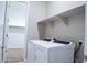 A laundry room with a view to the closet featuring a white washer and dryer set and white shelving above at 1255 N Arizona Ave # 1216, Chandler, AZ 85225