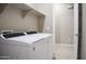A laundry room with a white washer and dryer set and white shelving above at 1255 N Arizona Ave # 1216, Chandler, AZ 85225