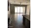 Bright living room with tiled flooring, large windows, ceiling fan, and slider door to backyard at 1255 N Arizona Ave # 1216, Chandler, AZ 85225