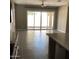 Bright living room with tiled flooring, large windows, ceiling fan, and slider door to backyard at 1255 N Arizona Ave # 1216, Chandler, AZ 85225