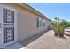Backyard showcasing desert landscaping with cacti, gravel, and a security door at 135 S Verde Ln, Casa Grande, AZ 85194