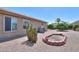 Well-kept backyard with desert landscaping, fire pit, and gravel, offering a tranquil outdoor retreat at 135 S Verde Ln, Casa Grande, AZ 85194