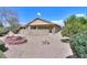 Backyard with low maintenance desert landscaping, mature trees, and rock firepit for outdoor enjoyment at 135 S Verde Ln, Casa Grande, AZ 85194