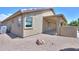 The backyard features a covered patio, a well-maintained landscape, and a durable gravel ground cover at 135 S Verde Ln, Casa Grande, AZ 85194