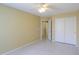 Bedroom featuring neutral walls, tile floors, ceiling fan and closet with doors at 135 S Verde Ln, Casa Grande, AZ 85194