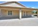 Spacious covered patio with decorative doors and an expansive concrete area for entertaining at 135 S Verde Ln, Casa Grande, AZ 85194