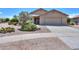 Inviting single-story home with desert landscaping and a covered entryway, plus a two car garage at 135 S Verde Ln, Casa Grande, AZ 85194