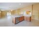 A well-lit kitchen with stainless steel appliances and beige tile flooring throughout open floor plan at 135 S Verde Ln, Casa Grande, AZ 85194