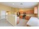 Modern kitchen with stainless steel appliances, wood cabinets, breakfast bar, and tile flooring at 135 S Verde Ln, Casa Grande, AZ 85194