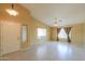Open-concept living room with natural light, tile floors, and vaulted ceiling at 135 S Verde Ln, Casa Grande, AZ 85194