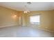 Spacious living room with tile floors, ceiling fan, and large windows at 135 S Verde Ln, Casa Grande, AZ 85194
