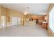 Large open-plan living area with tiled flooring, kitchen view, and recessed lighting at 135 S Verde Ln, Casa Grande, AZ 85194