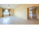 Bright and spacious living room with tile flooring, vaulted ceiling, and views to dining and kitchen at 135 S Verde Ln, Casa Grande, AZ 85194