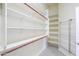 Bright walk-in closet featuring shelving, rods and shoe rack for organized storage space at 135 S Verde Ln, Casa Grande, AZ 85194