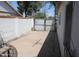 Backyard view of a concrete pad and block wall with metal gate at 1367 E Clarendon Ave, Phoenix, AZ 85014