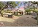 Expansive backyard showcasing desert landscaping, a cozy seating area, and an outdoor dining space for relaxing or entertaining at 14945 N 102Nd St, Scottsdale, AZ 85255