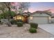 Charming single-story home with desert landscaping, red tile roof, and inviting curb appeal at dusk at 14945 N 102Nd St, Scottsdale, AZ 85255