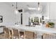 Bright kitchen with white cabinets, quartz countertops, breakfast bar, and pendant lighting at 14945 N 102Nd St, Scottsdale, AZ 85255