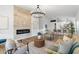 Open-concept living area with a modern fireplace, pendant lighting, and views of the kitchen at 14945 N 102Nd St, Scottsdale, AZ 85255