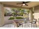 Covered patio providing a shaded retreat overlooking the landscaped backyard with desert foliage and charming details at 14945 N 102Nd St, Scottsdale, AZ 85255