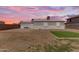A wide backyard with an expansive patio and desert landscaping, perfect for outdoor living at 1511 E Harmony Ave, Mesa, AZ 85204