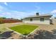 A gravel-covered backyard featuring a square patch of green turf at 1511 E Harmony Ave, Mesa, AZ 85204
