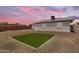 Cozy backyard with a small patch of green grass, ideal for play and relaxation at 1511 E Harmony Ave, Mesa, AZ 85204
