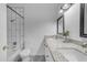 Bright bathroom featuring dual sinks, decorative tile floor, and granite vanity at 1511 E Harmony Ave, Mesa, AZ 85204