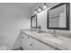 Updated bathroom with dual sinks, decorative tile floor, and granite vanity at 1511 E Harmony Ave, Mesa, AZ 85204