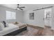 Serene bedroom with modern design elements, hardwood floors, and ample natural light at 1511 E Harmony Ave, Mesa, AZ 85204