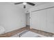 Bedroom with a fan, wood-look floors, and closet at 1511 E Harmony Ave, Mesa, AZ 85204
