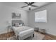 Cozy bedroom featuring a ceiling fan, window, and wood-look flooring at 1511 E Harmony Ave, Mesa, AZ 85204