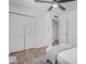 Neutral bedroom with a fan, wood-look floors, and closet at 1511 E Harmony Ave, Mesa, AZ 85204