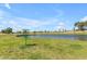 Community disc golf basket with a pond and green space in the background at 1511 E Harmony Ave, Mesa, AZ 85204