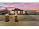 Charming brick home with a well-manicured yard under a breathtaking sunset sky at 1511 E Harmony Ave, Mesa, AZ 85204