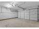 Spacious garage featuring a clean painted floor, bright lighting, and large doors at 1511 E Harmony Ave, Mesa, AZ 85204