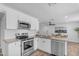 Modern kitchen features stainless steel appliances, white cabinets, and granite countertops at 1511 E Harmony Ave, Mesa, AZ 85204