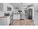 Bright and modern kitchen features white cabinets, and stainless steel appliances at 1511 E Harmony Ave, Mesa, AZ 85204