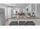 Open-concept kitchen featuring granite countertops and a view of the well-lit living area at 1511 E Harmony Ave, Mesa, AZ 85204