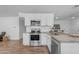 Modern kitchen featuring stainless steel appliances, granite countertops, and bright white cabinetry at 1511 E Harmony Ave, Mesa, AZ 85204