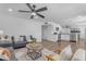 Bright, open-concept living room with modern furnishings and hardwood floors at 1511 E Harmony Ave, Mesa, AZ 85204