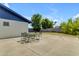 Back patio features seating for 4 in a spacious setting surrounded by greenery at 1511 E Harmony Ave, Mesa, AZ 85204