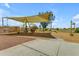 Community playground featuring a shade structure, climbing nets, and swings for to enjoy at 1511 E Harmony Ave, Mesa, AZ 85204