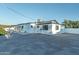 Backyard featuring white walls, dark trim, shade covering, and a large parking area at 1539 W Puget Ave, Phoenix, AZ 85021