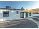 Exterior of home with a large backyard, shade covering, concrete walkway, and dark trim at 1539 W Puget Ave, Phoenix, AZ 85021
