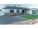A charming home features a brick facade, black trim, and manicured front yard with new landscaping at 1539 W Puget Ave, Phoenix, AZ 85021