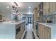 A modern kitchen features wood-tone cabinetry, quartz countertops, and a mosaic tile backsplash at 1539 W Puget Ave, Phoenix, AZ 85021