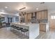 A modern kitchen features a large island, wooden cabinets, and stainless steel appliances at 1539 W Puget Ave, Phoenix, AZ 85021